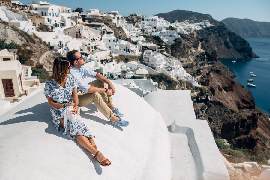 couple sitting on roof in Santorini